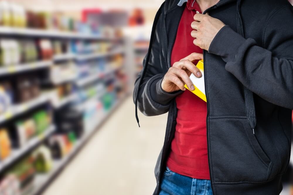 man stealing in supermarket.