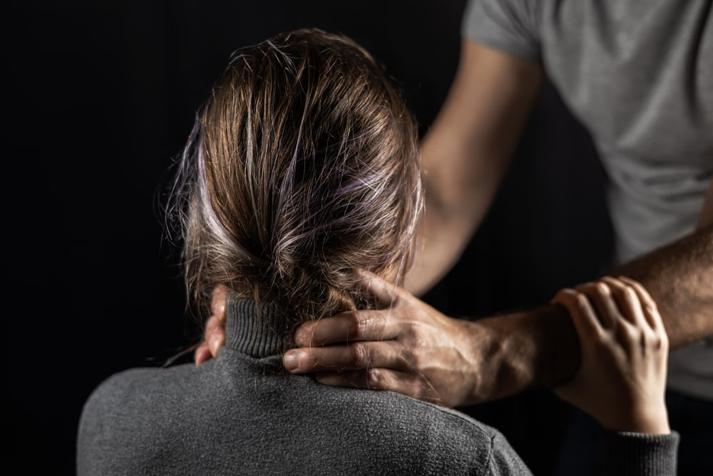 assault concept with mans hands strangling a woman's neck